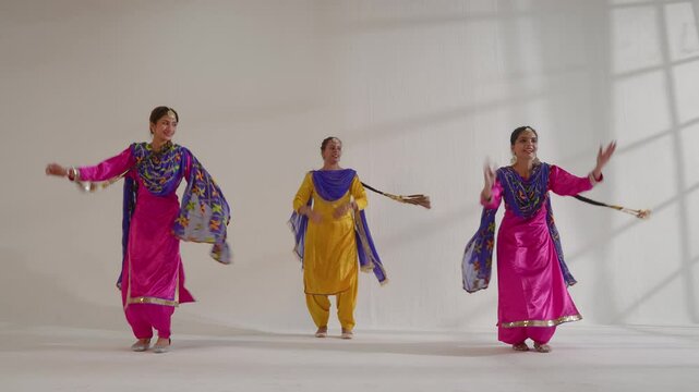 Three Sikh Women performing bhangra during Baisakhi celebration