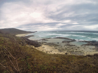 A Serene Coastal Landscape that features Rolling Waves and a Rocky Shoreline that captivates K'gari Fraser Island Australia