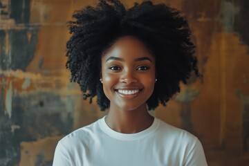 Fototapeta premium close up portrait of a black woman with afro hair wearing a white t-shirt on a mocha background studio shot