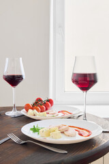 A Beautifully Elegant Dinner Setting Featuring Exquisite Wine and Appetizers for Enjoyment