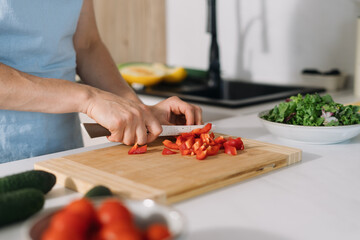 Woman preparing fresh vegetables for a healthy meal in a modern kitchen