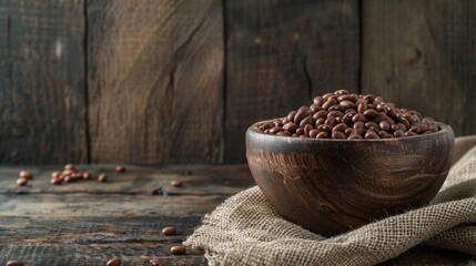 Wooden bowl of beans on burlap, symbolizing vegan protein sources.
