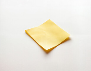 This image highlights a solitary yellow sticky note placed against a clean, light background. The simplicity of the composition emphasizes functionality and minimalism, making it a perfect representat