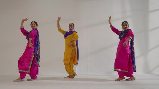Three Sikh Women performing bhangra during Baisakhi celebration