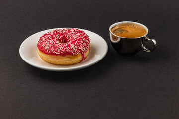 Wonderful fragrant espresso and a fresh donut with red glaze