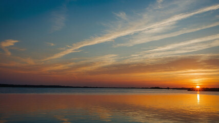 Naklejka premium Sunset reflections on calm water