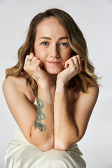 Fototapeta premium Woman with vitiligo poses gracefully, showing her beauty and confidence in a calm environment.