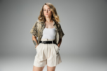 Woman with vitiligo shows her style in light shorts and a patterned shirt.