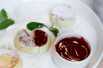 Cottage cheese pancakes, syrniki with fresh berries and jam for breakfast 