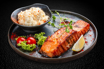 Salmon steak with creamy rice. A succulent salmon fillet, perfectly grilled or pan-seared, served alongside a bed of rich, creamy rice.
