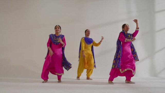 Three Sikh Women performing bhangra during Baisakhi celebration