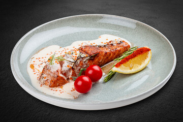 Salmon steak with cream sauce and red caviar