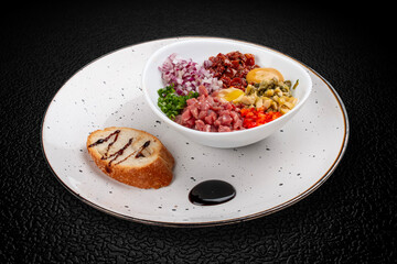 Beef tartare with olives, sweet peppers, and sun-dried tomatoes.