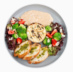 Grilled Camembert cheese served with creamy sauce and vegetables.