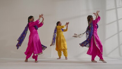 Three Sikh Women performing bhangra during Baisakhi celebration