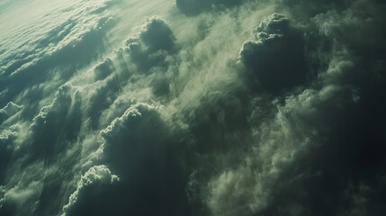 Fototapeta premium A cloudscape view from an airplane window with sunlight streaming through gaps in the clouds.