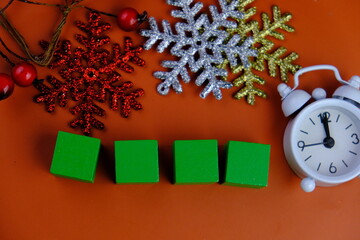 Season's greetings scene. Top view of Christmas decorations, balls, rustic star, holly berries,...