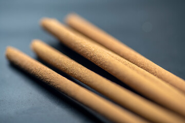 Closeup view of incense sticks for ritual, praying, or aromatic scented on a black background