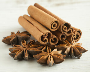 Spices displayed on a wooden surface showcasing cinnamon sticks and star anise pods