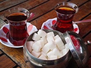 Enjoying Turkish cultural tea (çay) served in small tulip shaped glasses with sugar cubes