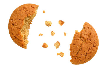 Oatmeal cookies broken in half with crumbs scattered chaotically. Isolated on a transparent...