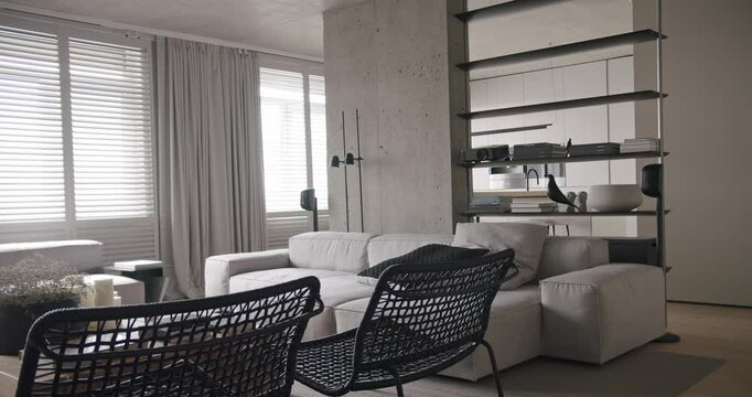 Modern living room. luxury minimalist design, real apartment with white and gray tones, elegance chair and luxury furniture, white carpet and black audio technica, with concrete, minimalist design