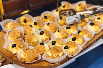 Catering table, beautifully decorated banquet with variety different food snacks appetizers on christmas corporate birthday party event or wedding celebration, canape, salad, delicatessen setting