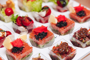 Catering table, beautifully decorated banquet with variety different food snacks appetizers on christmas corporate birthday party event or wedding celebration, canape, salad, delicatessen setting