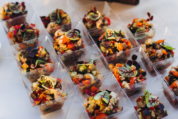 Catering table, beautifully decorated banquet with variety different food snacks appetizers on christmas corporate birthday party event or wedding celebration, canape, salad, delicatessen setting