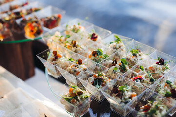Catering table, beautifully decorated banquet with variety different food snacks appetizers on christmas corporate birthday party event or wedding celebration, canape, salad, delicatessen setting