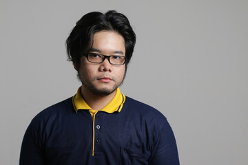 Obraz premium close up portrait of a cool Asian man with flat and serious expression