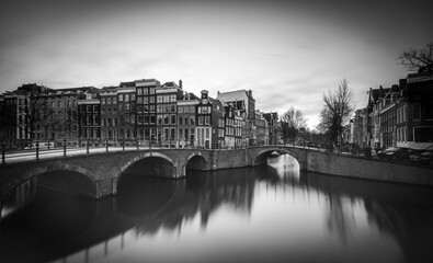 Charming canals of Amsterdam reflect historic architecture at dusk