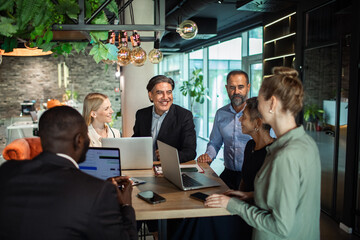 Business team collaborating on project in modern office environment
