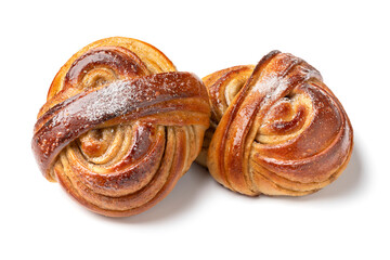 Pair of homemade fresh baked swedish cardamom bun isolated on white background close up