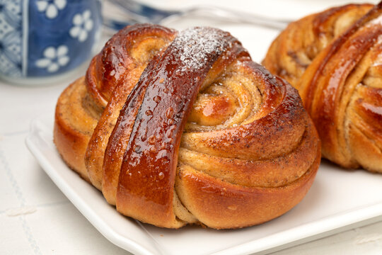 Plate with homemade fresh baked swedish cardamom buns close up