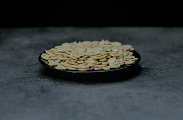 Pumpkin seeds on dark background