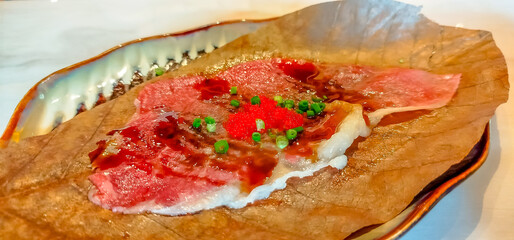 Beef grill on oba leaf cook in Japanese style on personal rack oven on table in Japanese style restaurant