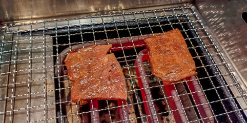 Pieces of beef grilled on rack with oven in Japanese style in restaurant