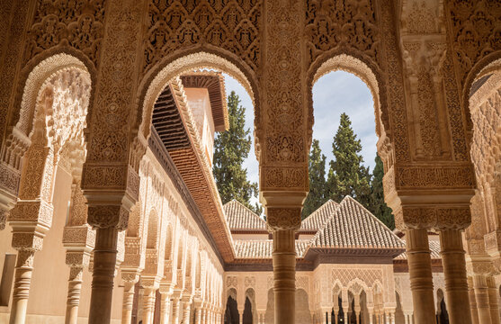 Court of the Lions surrounding with arches and columns decorated incredible details of stucco yeseria decoration, with sebka motif, arabesques, and muqarnas sculpting - art of Moorish architecture.