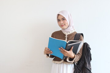 Smiling Muslim Student Girl with Books and Backpack against White Background