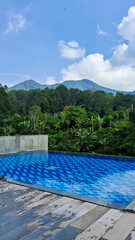 Infinity swimming pool and mountains in summer