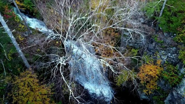 Aerial footage of Bushkill Falls in Lehman Township, Pennsylvania, capturing the stunning waterfalls amidst the Pocono Mountains, surrounded by lush greenery and rugged terrain breathtaking nature