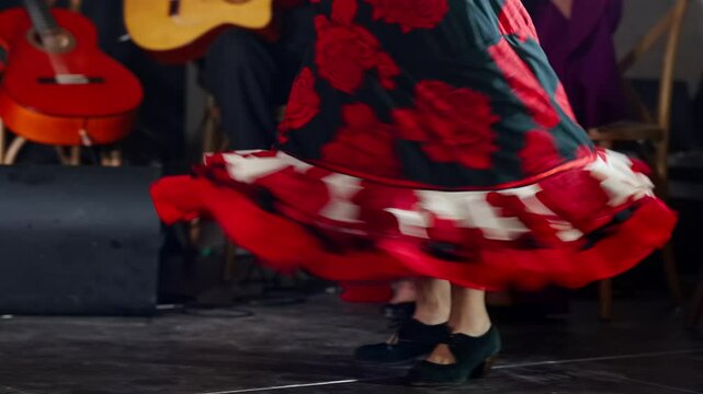 Graceful woman in vibrant dress shows giros moves on stage