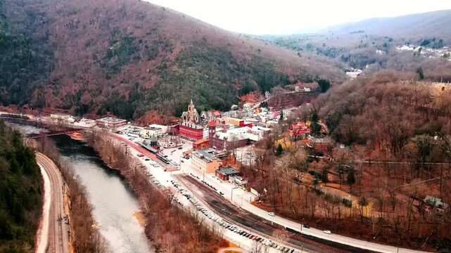 Aerial footage of Jim Thorpe, Pennsylvania, USA, capturing the town's charming streets, historic landmarks, buildings, roads, scenic landscapes, and vibrant neighbourhoods. A picturesque aerial view!