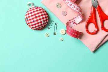 Flat lay composition with different sewing supplies on color background