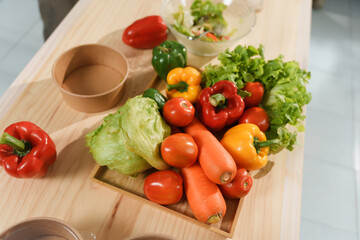 Freshly picked vegetables arranged on wooden table, ready for preparing healthy meal
