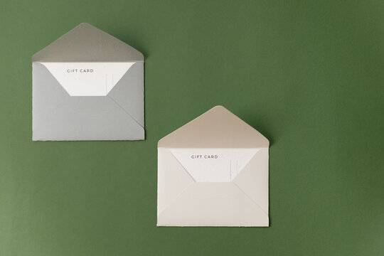 Gift certificate and envelope on green background - Powered by Adobe