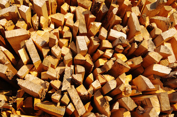 Stack of pine scraps from logs in a sawmill yard. Lumber for construction or material for firewood