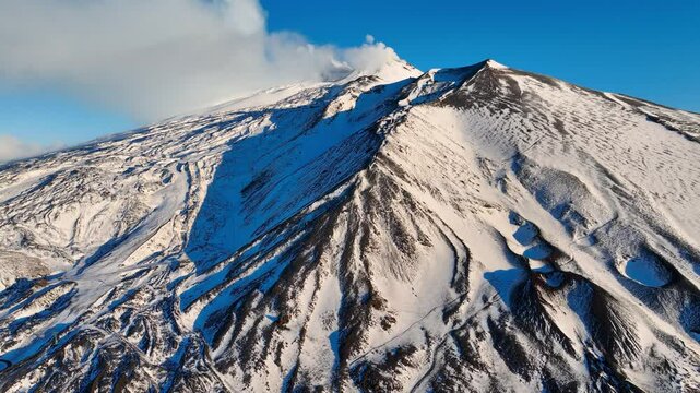 Etna volcano covered with snow in winter, aerial view, Etna volcano in Sicily, Italy, Sicilian landmark Etna volcano drone view, travel in Sicily