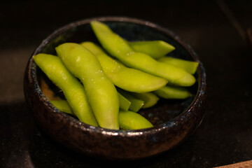 Edamame is an East Asian dish prepared with immature soybeans in their pods, which are boiled or steamed.